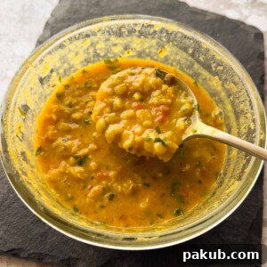 Microwave Dal Tadka - a bowl of yellow lentils garnished with coriander