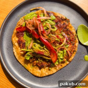 Crispy Indian-style chicken smash taco, beautifully plated.