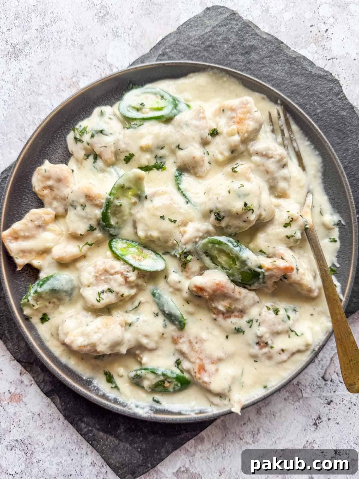 creamy japan chicken served on a plate with fork