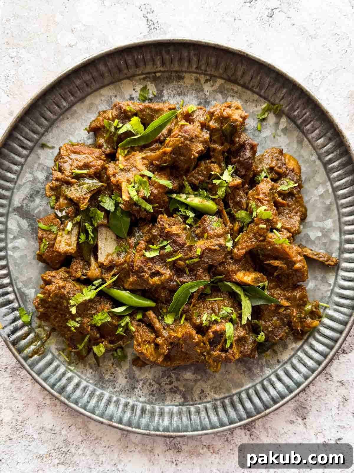 Quick & Tender Pepper Mutton Fry 3 Close-up of Pepper Mutton Fry, showing the tender mutton pieces and rich, dark masala.