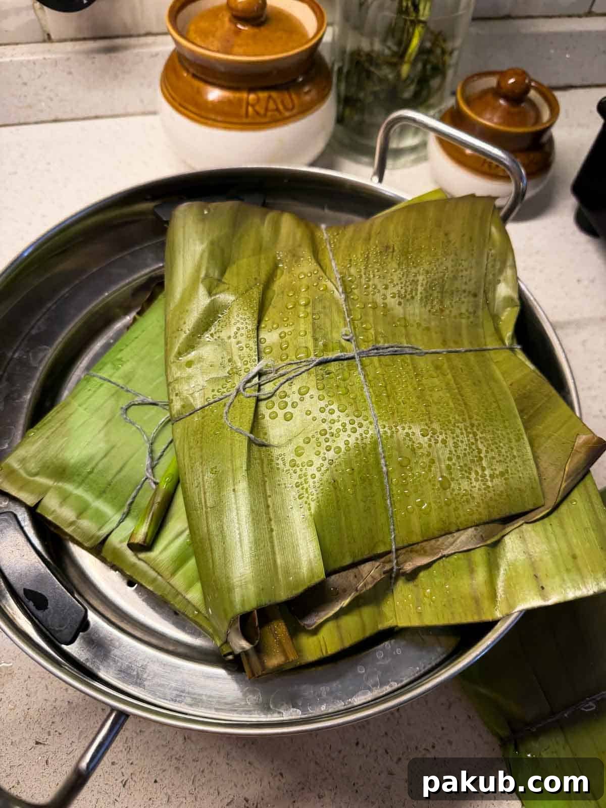 Vegetable Parcel Biryani 3 freshly steamed veg potli biryani ready in the banana leaf wrapping