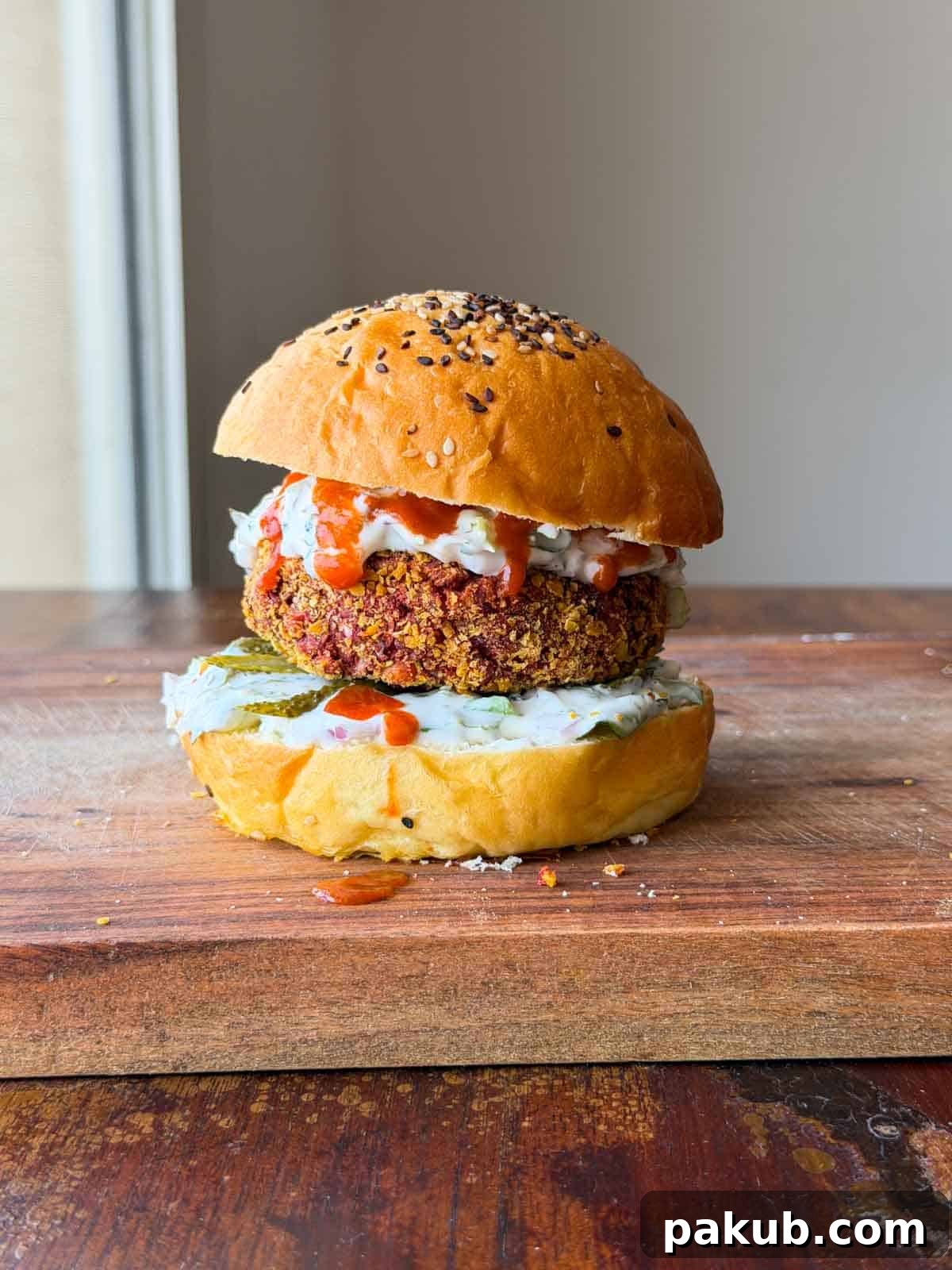 A beautifully assembled Rajma Paneer Burger, topped with fresh ingredients and ready to be served, highlighting its appealing presentation.