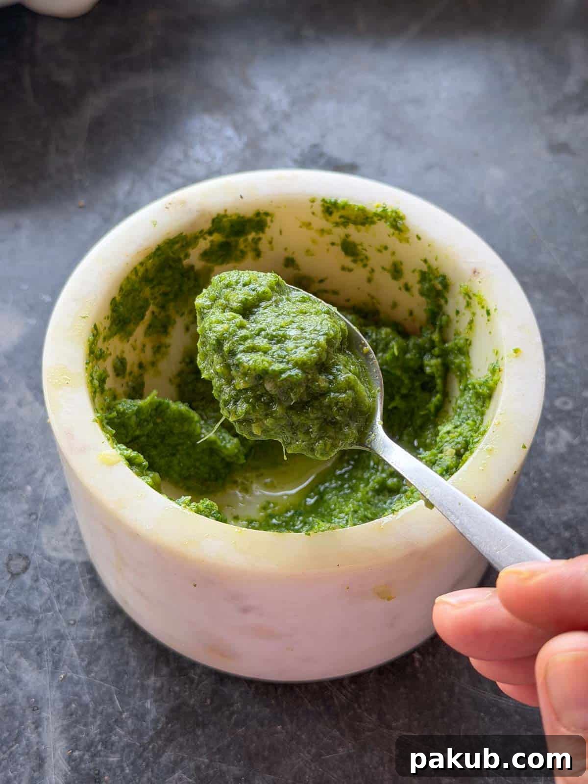 the green chutney for masala stuffed egg spooned up to showcase color and texture