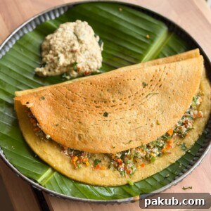 Protein-Packed Moong Dal Chilla with Savory Filling 6 Stuffed Moong Dal Chilla served with chutney on the side on a banana leaf plate