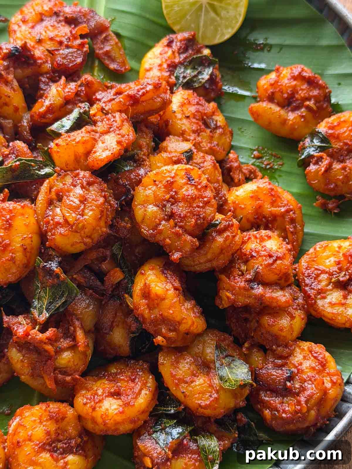 Kerala Prawn Roast: Spicy Coconut Shrimp from South India 3 kerala prawn roast served over a banana leaf