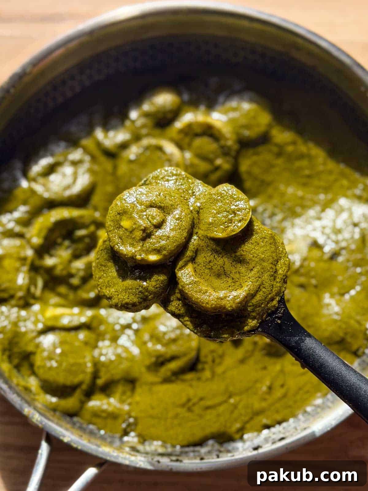 green egg curry in it's cooking vessel ready for serving