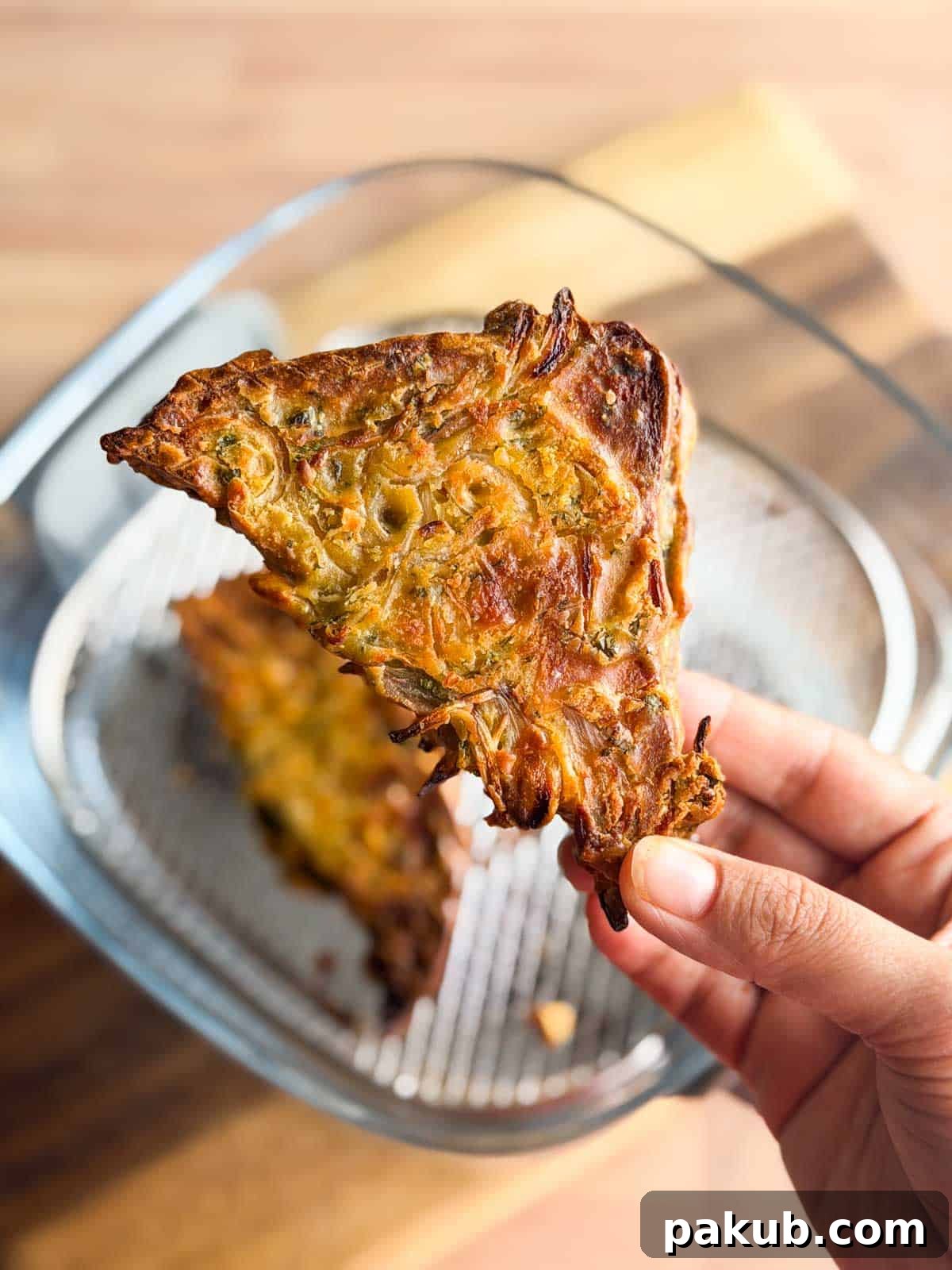 Crispy Air Fryer Bread Pakoras 4 a person a holding up a piece of air fryer bread pakora to show it's crispy texture and color