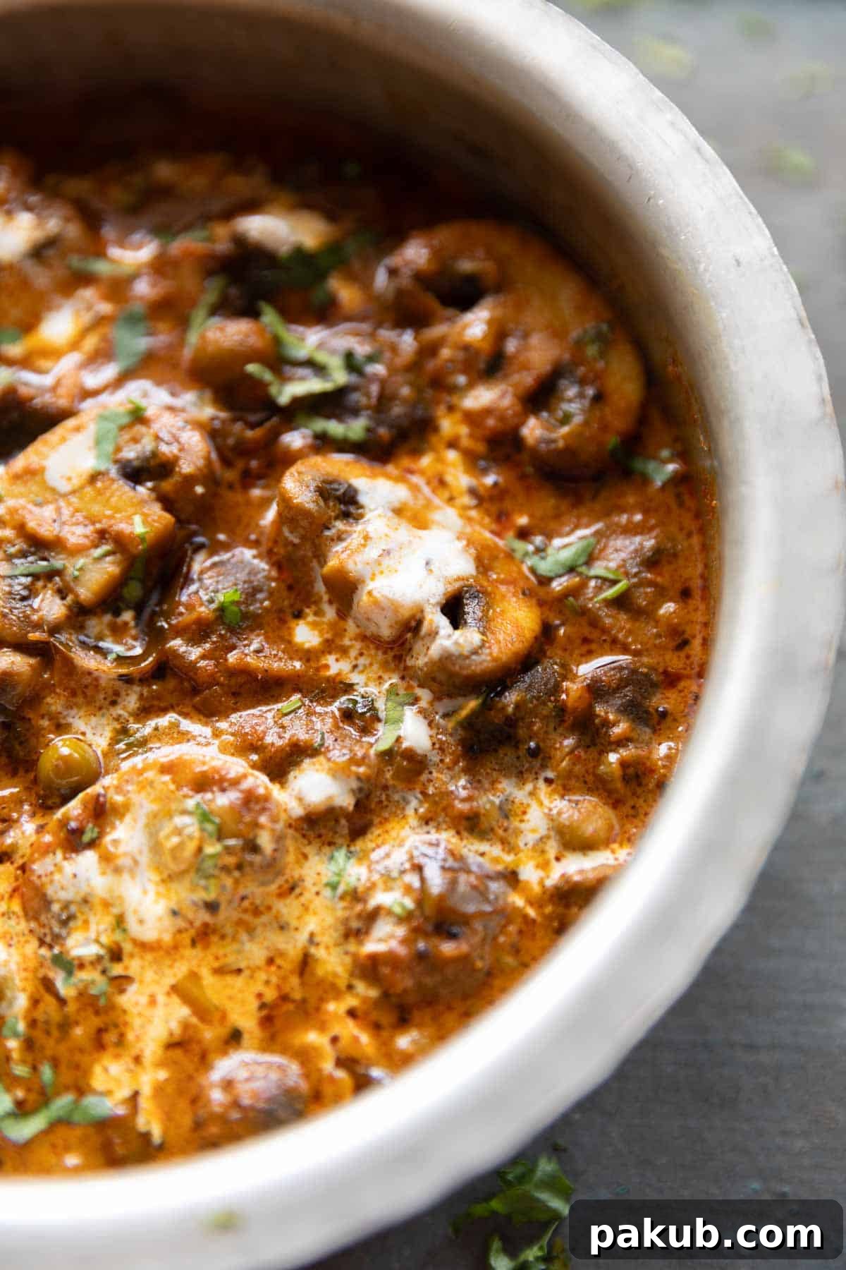 a close up image of half of the mushroom masala serving bowl to showcase it's color and texture
