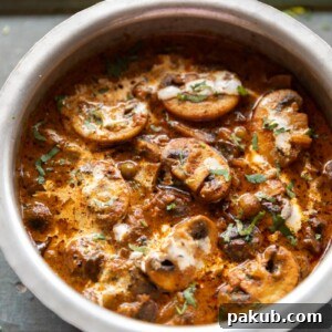 mushroom masala in a steel bowl ready for serving