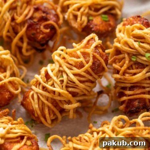 Many pieces of thread paneer served on a tissue paper lined plate