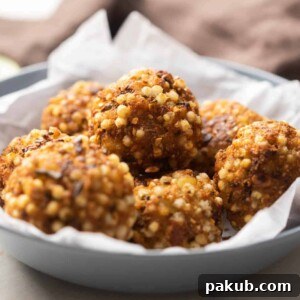 Closeup of sabudana vada bombs stuffed with paneer stacked on top of one another