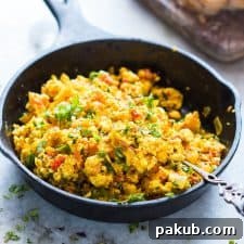 Paneer bhurji in a black skillet.