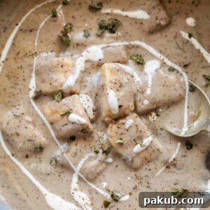 paneer kali mirch gravy served in a bowl with cream drizzled on top