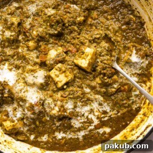 Picture of saag paneer in the pan that it was cooked in with a spoon