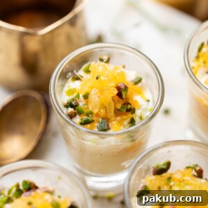 Orange kalakand served in shot glasses and topped with orange segments and chopped nuts