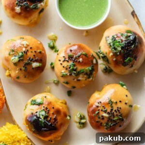Naan bombs served on a platter with mint chutney and marigold flowers strewn about