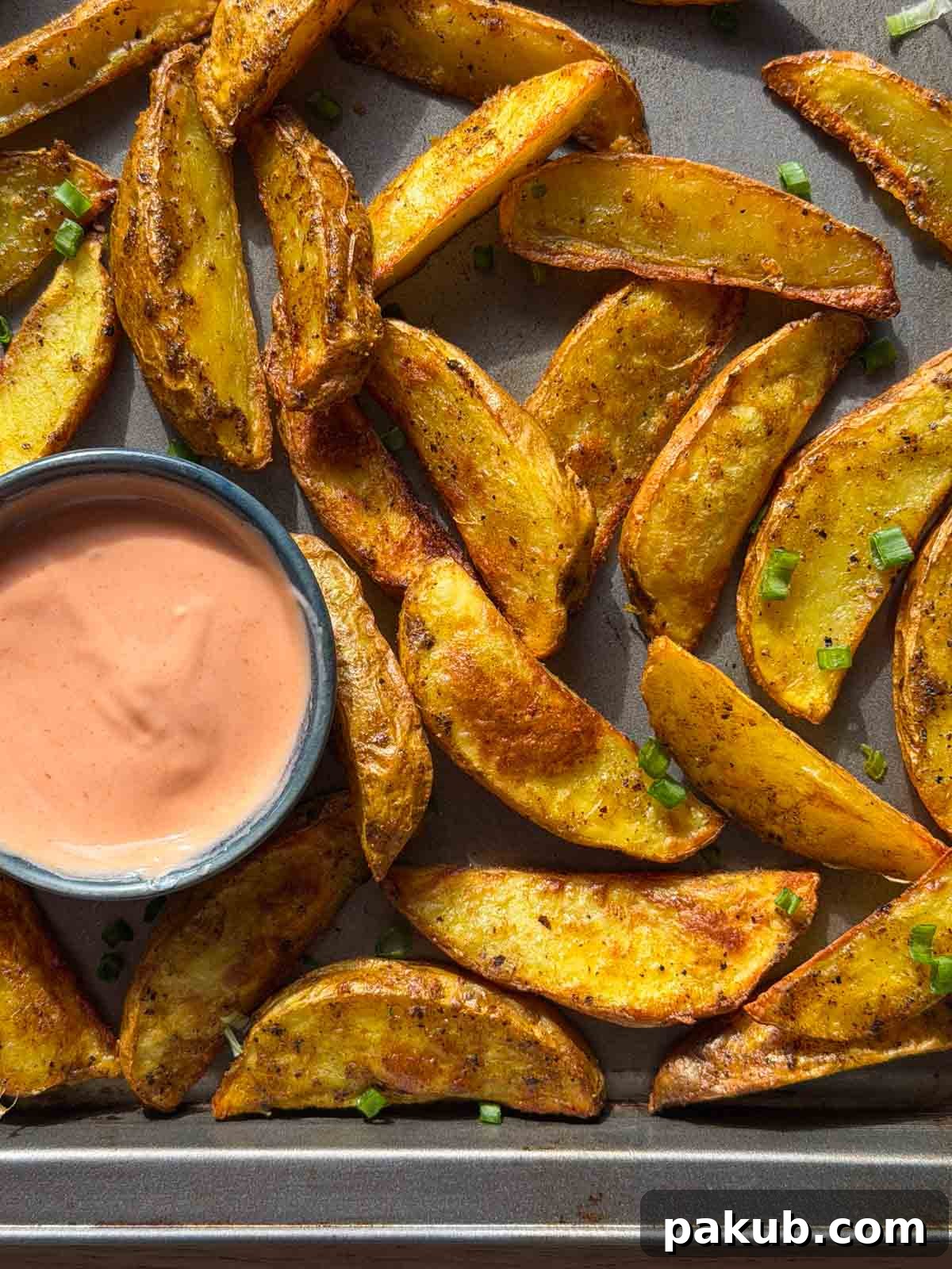 Crispy Masala Potato Wedges in the Air Fryer 3 air fryer potato wedges with an accompanying dip