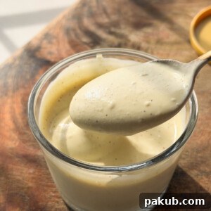 Protein-Packed Egg-Free Veggie Mayonnaise 5 smooth and creamy veg mayo scooped up in a spoon