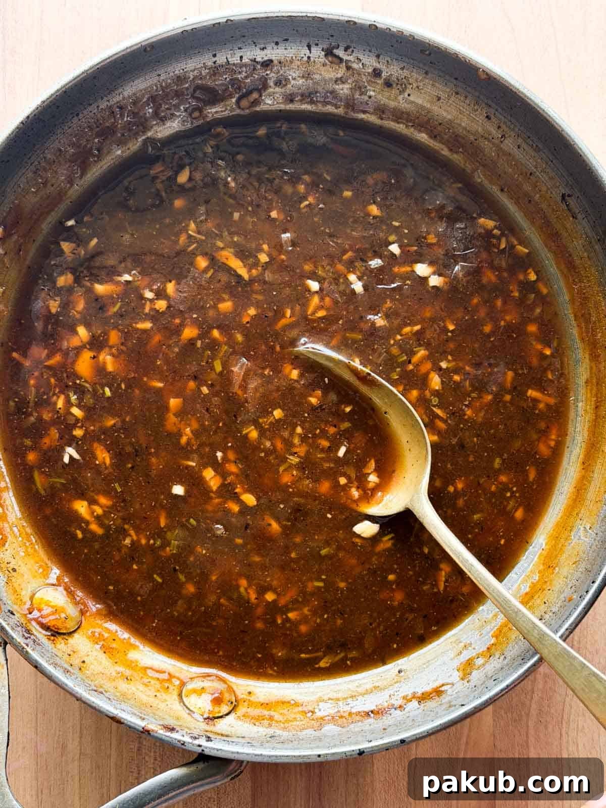 chicken sizzler sauce in a pan with spoon