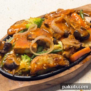 Paneer Sizzler with Tangy Shashlik Sauce 6 paneer sizzler assembled and ready to be served