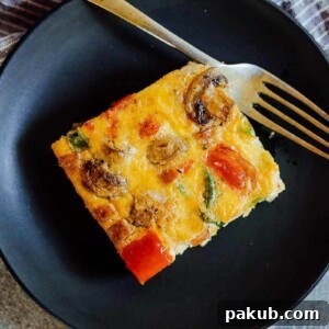 A slice of baked denver omelet breakfast casserole on a plate.