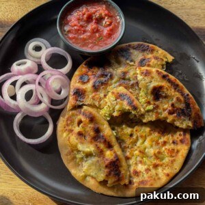 High Protein Stuffed Broccoli Paneer Paratha Recipe 5 broccoli paneer paratha served on a black plate with accompaniments