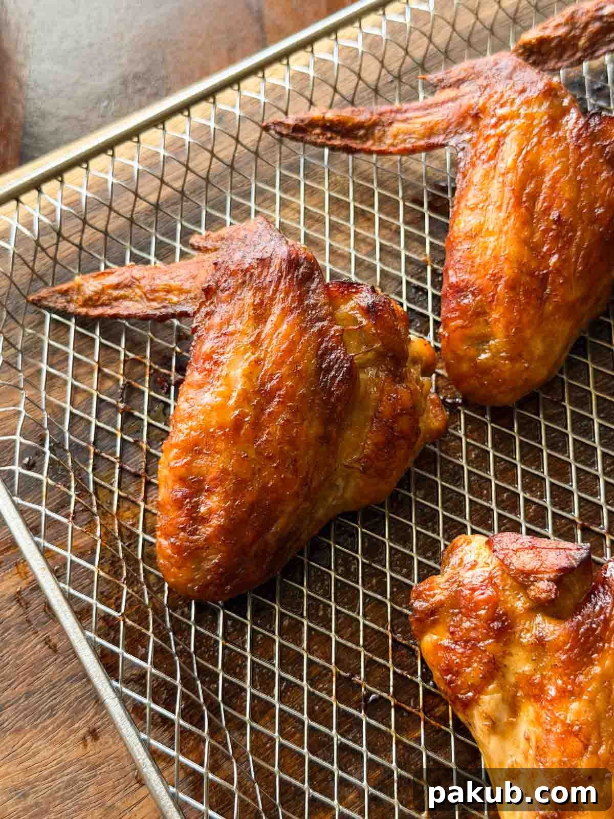 Crispy Soy Sauce Chicken Wings in the Air Fryer 3 soy chicken wings in the air fryer tray ready to be served