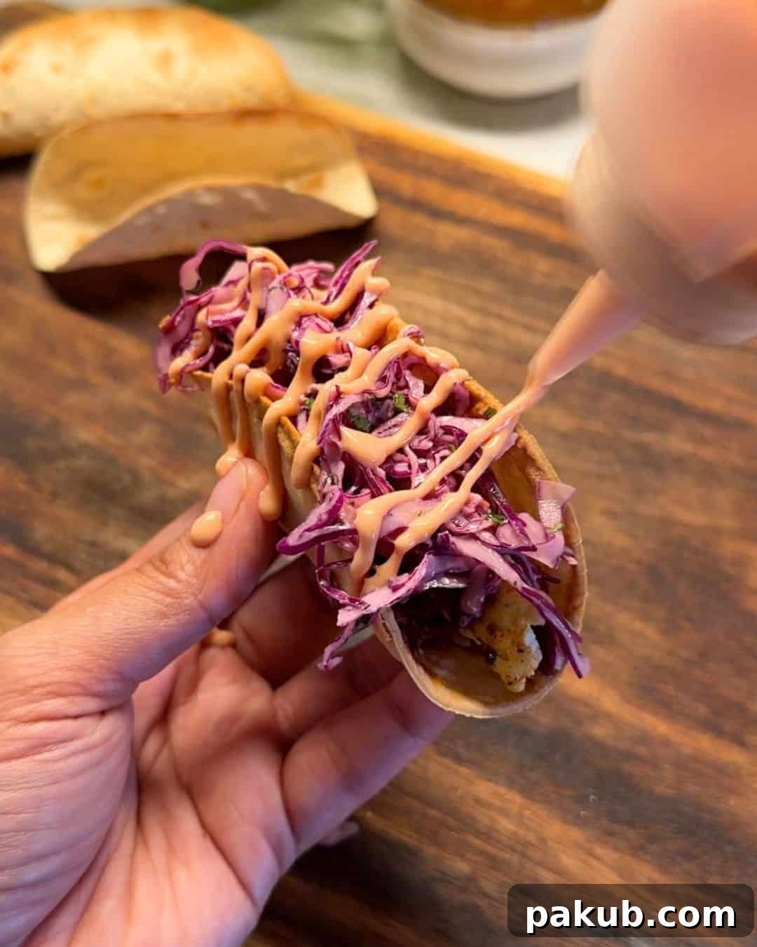 Mexican-Style Paneer Tacos Recipe 2 a person holding a Mexican paneer taco