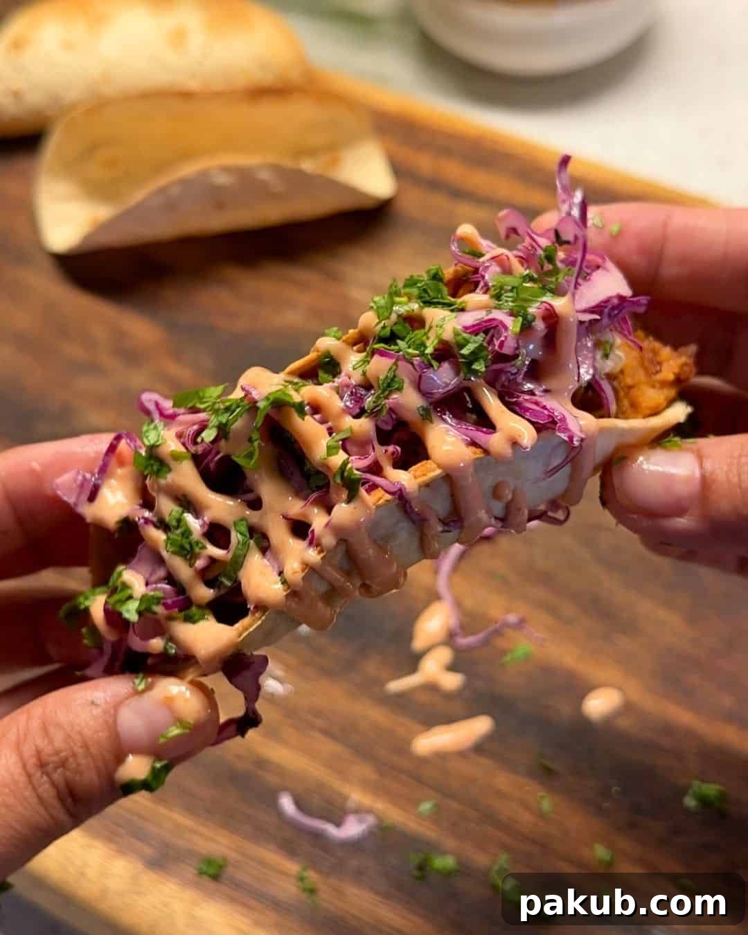 Mexican-Style Paneer Tacos Recipe 5 a person holding a Mexican paneer taco